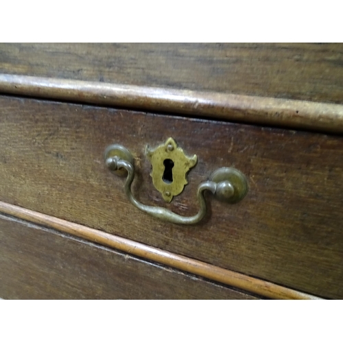 574 - An 18thC oak bureau with fall front over two short over two long drawers with swan neck handles. The... 