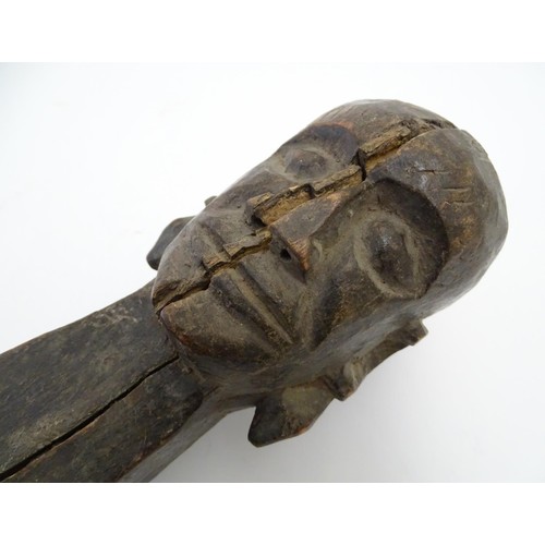 669 - Ethnographic / Native / Tribal: An African carved hardwood figure depicting an elongated woman stand... 