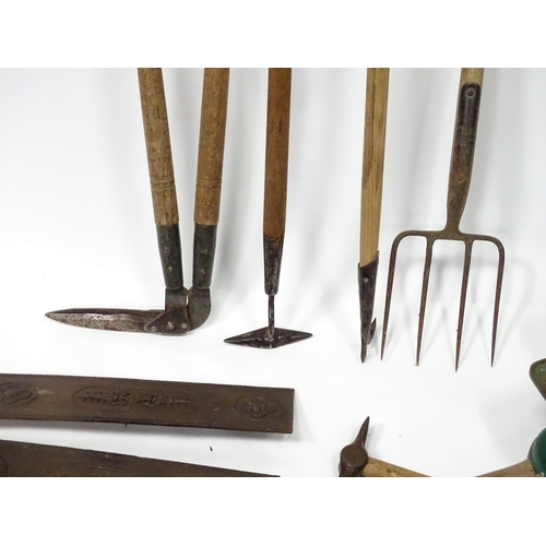 672 - A quantity of 20thC hand tools, including drills, hammer, saw, gardening implements, scales etc.