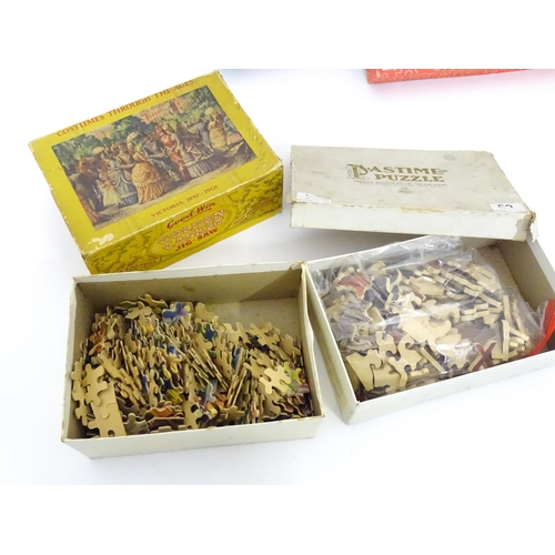 101 - Toys: A quantity of early to mid 20thC jigsaw puzzles, examples including period costumes, railways,... 