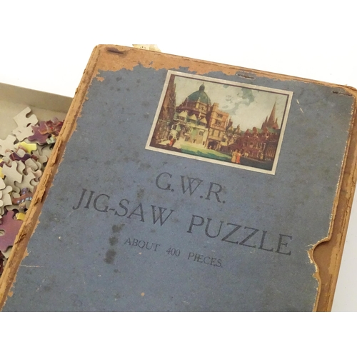 101 - Toys: A quantity of early to mid 20thC jigsaw puzzles, examples including period costumes, railways,... 