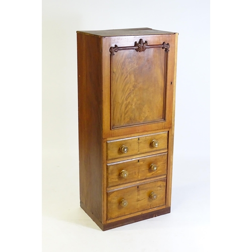 106 - A late 19thC / early 20thC mahogany cabinet with a panelled door above a three short drawers with tu... 