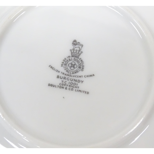 144 - A quantity of Royal Doulton dinner, tea and coffee wares in the Burgundy pattern to include plates, ... 