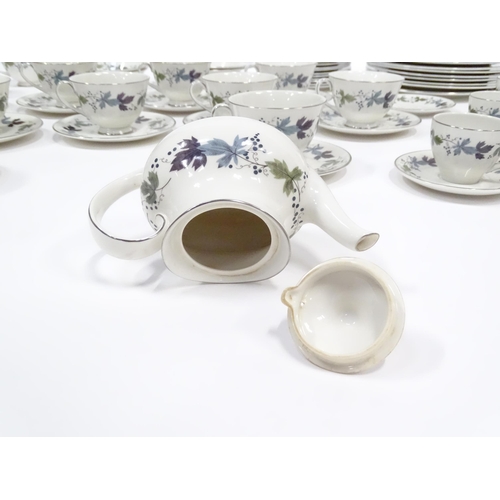 144 - A quantity of Royal Doulton dinner, tea and coffee wares in the Burgundy pattern to include plates, ... 