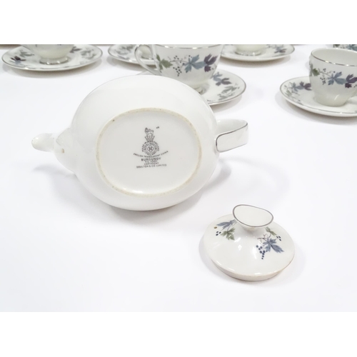 144 - A quantity of Royal Doulton dinner, tea and coffee wares in the Burgundy pattern to include plates, ... 