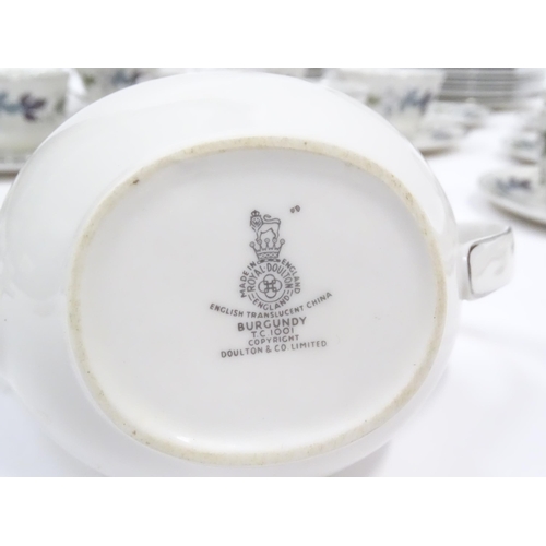 144 - A quantity of Royal Doulton dinner, tea and coffee wares in the Burgundy pattern to include plates, ... 