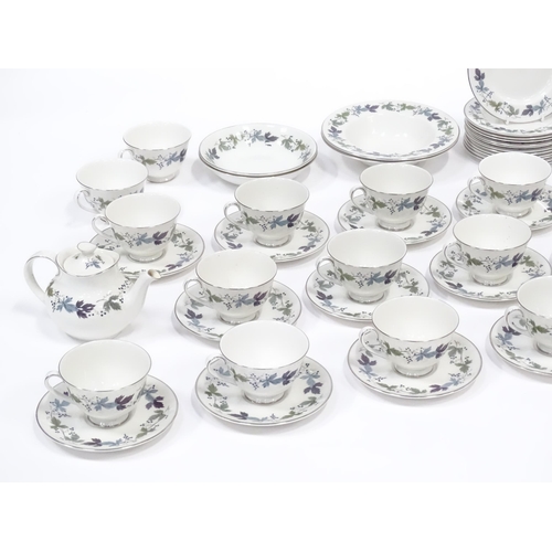 144 - A quantity of Royal Doulton dinner, tea and coffee wares in the Burgundy pattern to include plates, ... 