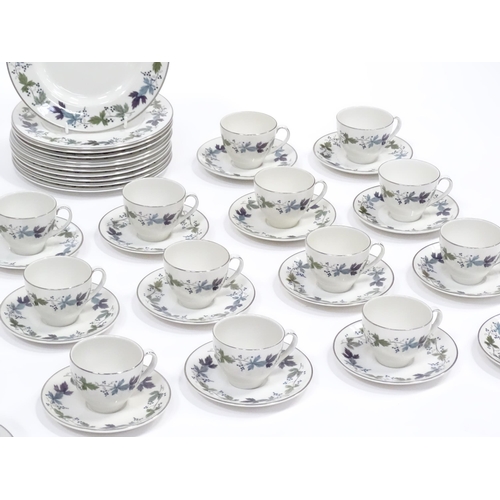 144 - A quantity of Royal Doulton dinner, tea and coffee wares in the Burgundy pattern to include plates, ... 