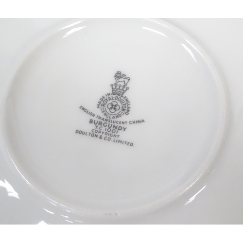 144 - A quantity of Royal Doulton dinner, tea and coffee wares in the Burgundy pattern to include plates, ... 