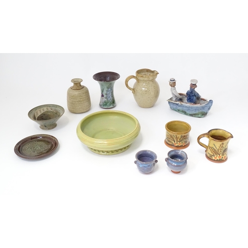 156 - A quantity of studio pottery wares to include a sugar jug and milk jug by Alan Frewin, a green bowl ... 