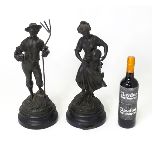 201 - Two 20thC French cast harvest figures, the female figure holding a flask, standing on a naturalistic... 