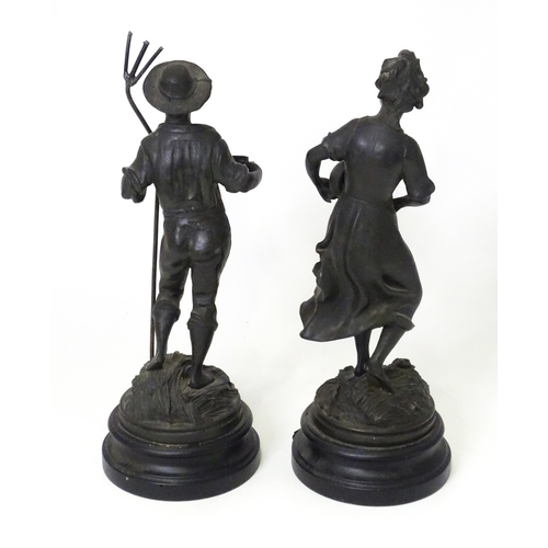 201 - Two 20thC French cast harvest figures, the female figure holding a flask, standing on a naturalistic... 