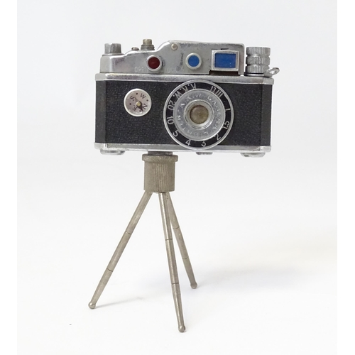 455 - A 20thC 'KKW Camera Lighter' novelty table top cigarette lighter modelled as a vintage camera on tri... 