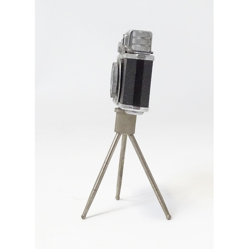 455 - A 20thC 'KKW Camera Lighter' novelty table top cigarette lighter modelled as a vintage camera on tri... 