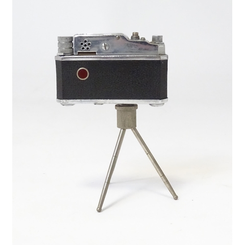 455 - A 20thC 'KKW Camera Lighter' novelty table top cigarette lighter modelled as a vintage camera on tri... 