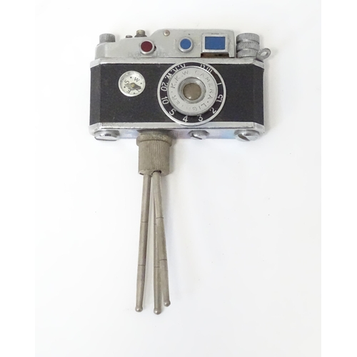 455 - A 20thC 'KKW Camera Lighter' novelty table top cigarette lighter modelled as a vintage camera on tri... 