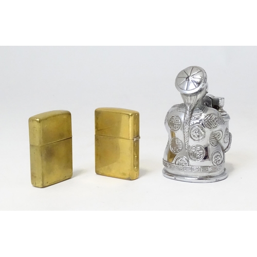 457 - A 20thC novelty table top lighter formed as a Chinese character, together with two c1990s Zippo pock... 