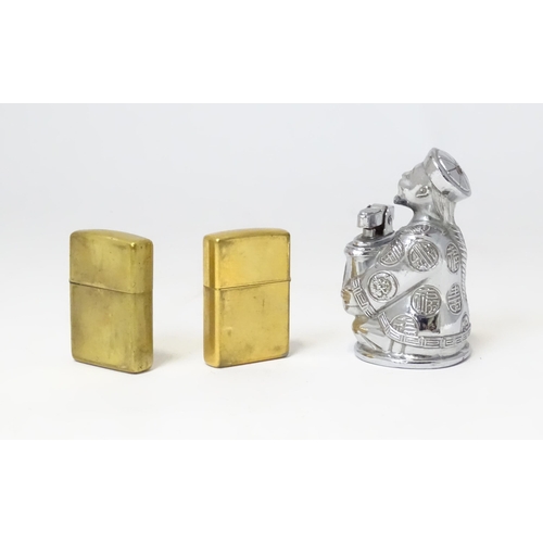 457 - A 20thC novelty table top lighter formed as a Chinese character, together with two c1990s Zippo pock... 