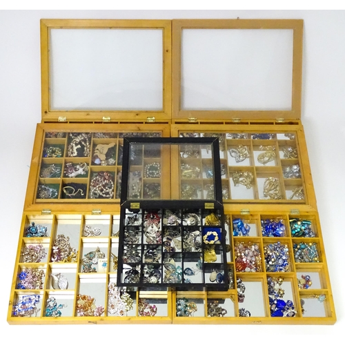 489 - A large quantity of assorted costume jewellery  to include earrings necklaces etc in display cases