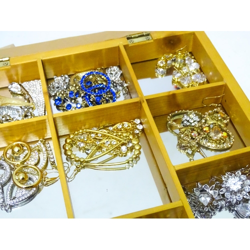 489 - A large quantity of assorted costume jewellery  to include earrings necklaces etc in display cases