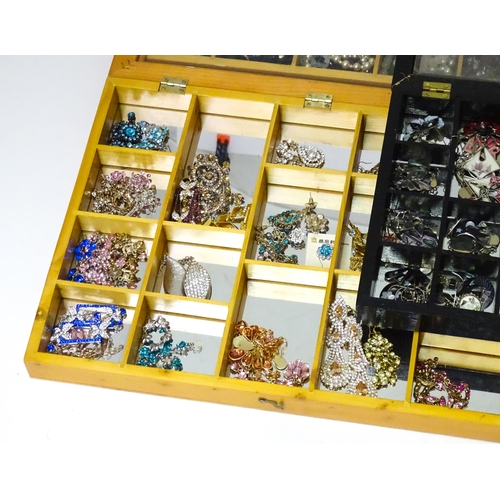 489 - A large quantity of assorted costume jewellery  to include earrings necklaces etc in display cases