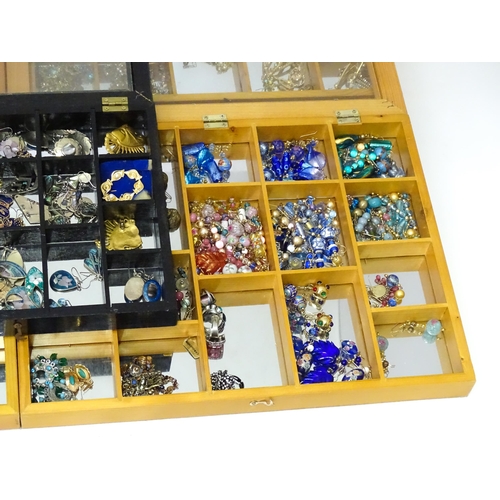 489 - A large quantity of assorted costume jewellery  to include earrings necklaces etc in display cases