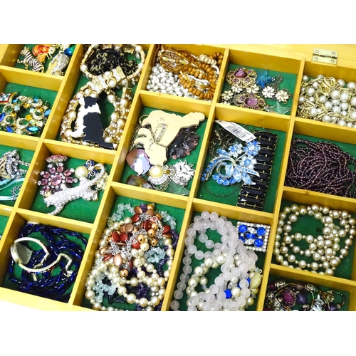 489 - A large quantity of assorted costume jewellery  to include earrings necklaces etc in display cases