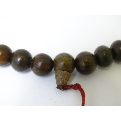 505 - An Oriental wooden bead necklace. Approx. 22