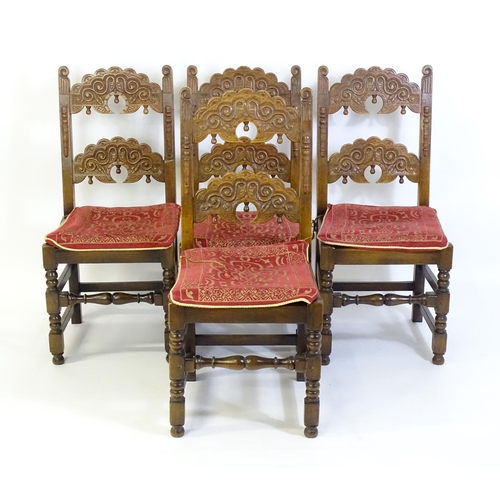 520 - A set of four mid 20thC oak dining chairs, with double braced backrest with carved decoration, the s... 