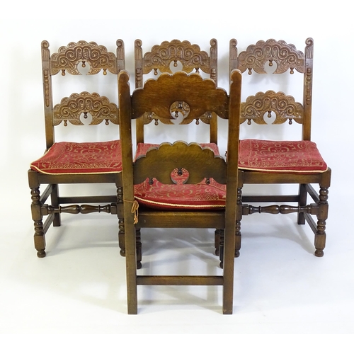 520 - A set of four mid 20thC oak dining chairs, with double braced backrest with carved decoration, the s... 