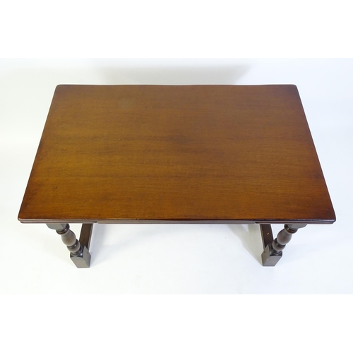 522 - A mid 20thC draw leaf dining table, with four block and turned legs united by a H - stretcher. 48