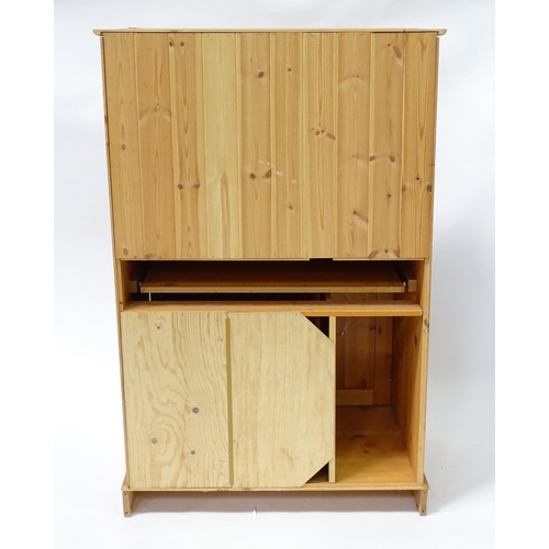 555 - A modern pine cupboard with two panelled doors with turned knob handles and having a fitted interior... 