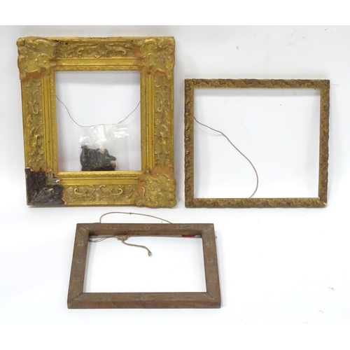 562 - Three picture / mirror frames, to include a gilt swept frame, a carved wooden example etc. Largest a... 