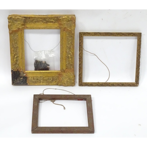 562 - Three picture / mirror frames, to include a gilt swept frame, a carved wooden example etc. Largest a... 