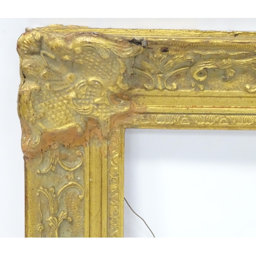 562 - Three picture / mirror frames, to include a gilt swept frame, a carved wooden example etc. Largest a... 