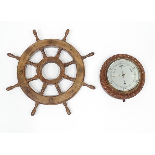 563 - A late 20thC display ships wheel, together with an oak cased aneroid barometer. The largest approx 2... 