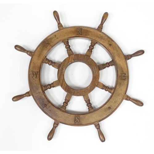 563 - A late 20thC display ships wheel, together with an oak cased aneroid barometer. The largest approx 2... 