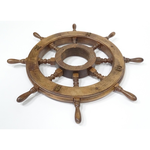 563 - A late 20thC display ships wheel, together with an oak cased aneroid barometer. The largest approx 2... 