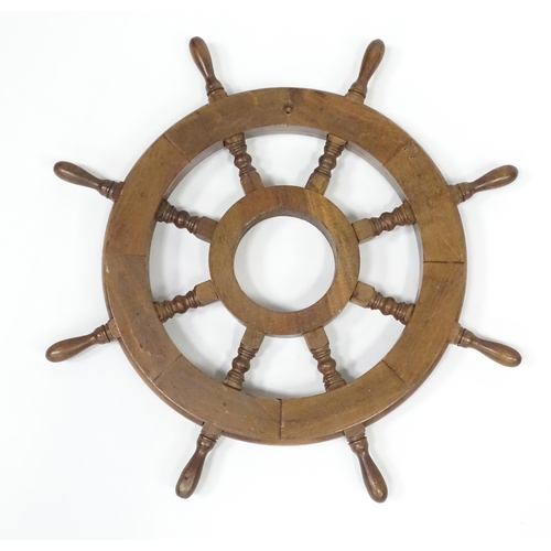 563 - A late 20thC display ships wheel, together with an oak cased aneroid barometer. The largest approx 2... 