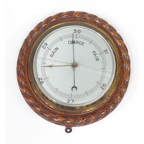 563 - A late 20thC display ships wheel, together with an oak cased aneroid barometer. The largest approx 2... 