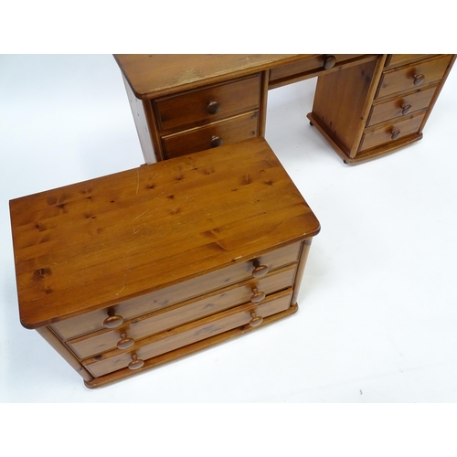 673 - A pine double pedestal desk with two banks of four short drawers and a draw to the centre. Together ... 