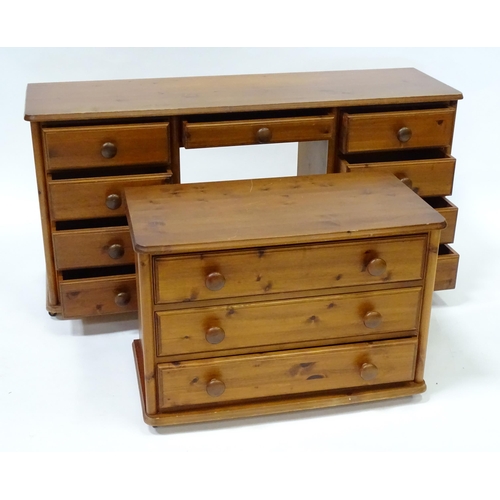 673 - A pine double pedestal desk with two banks of four short drawers and a draw to the centre. Together ... 