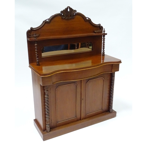 678 - A Victorian mahogany chiffonier with a mirrored upstand above two panelled doors flanked by barley t... 