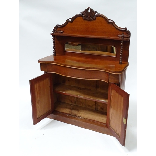 678 - A Victorian mahogany chiffonier with a mirrored upstand above two panelled doors flanked by barley t... 