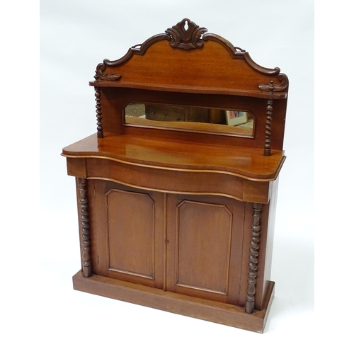 678 - A Victorian mahogany chiffonier with a mirrored upstand above two panelled doors flanked by barley t... 