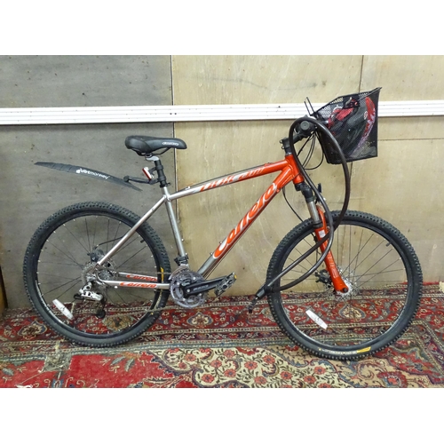 827 - Two adult mountain bikes, comprising a Carrera Vulcan (with basket) and a Saracen Mantra. With locks... 