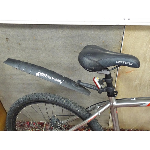 827 - Two adult mountain bikes, comprising a Carrera Vulcan (with basket) and a Saracen Mantra. With locks... 