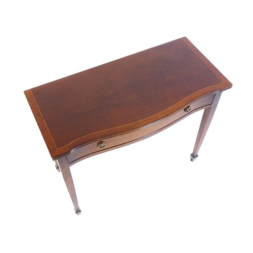 841 - A 20thC mahogany side table, with a serpentine shaped front, reeded edge and decoratively strung top... 