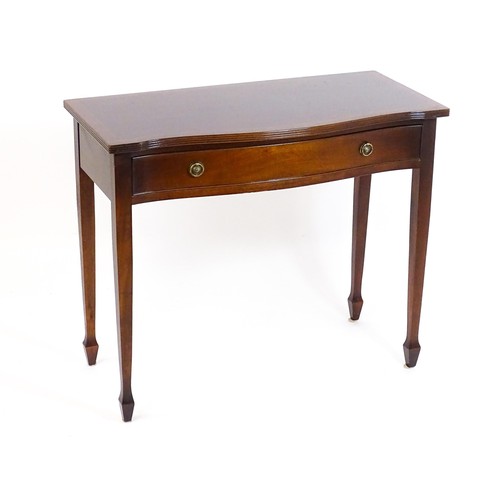 841 - A 20thC mahogany side table, with a serpentine shaped front, reeded edge and decoratively strung top... 