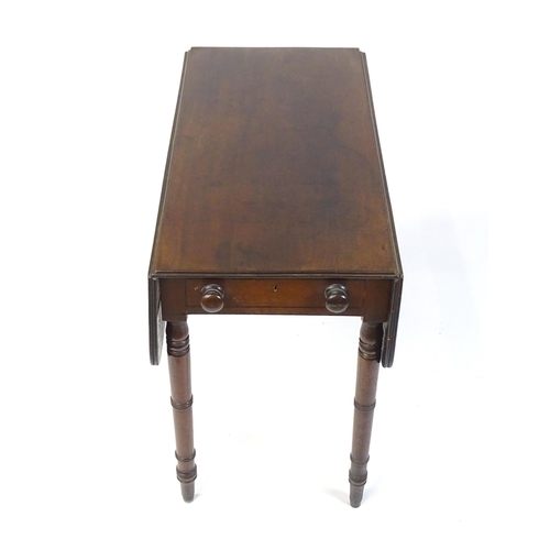 844 - A 19thC mahogany Pembroke table with two drop flaps, flanking a central short drawer and raised on t... 